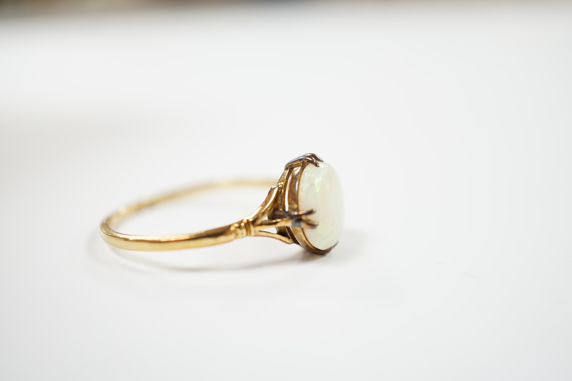 An 18ct and single stone white opal set ring, size S, gross weight 2.5 grams.